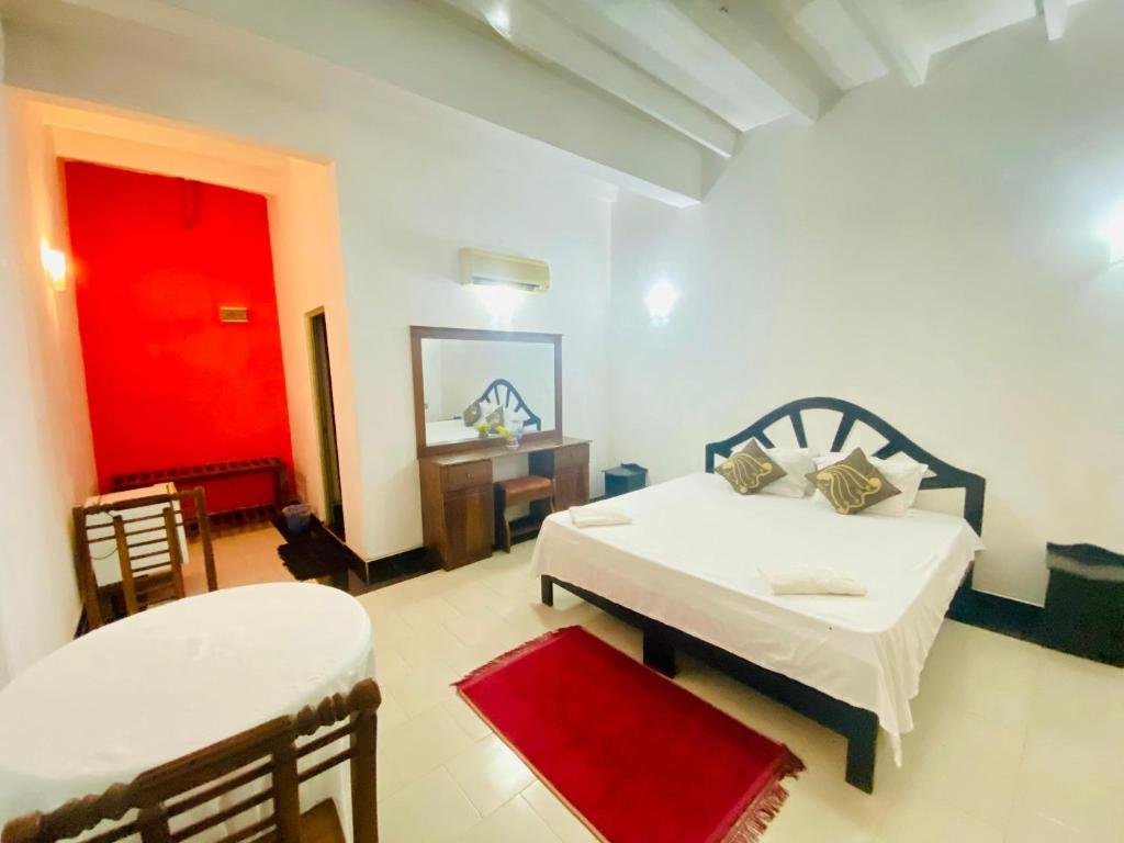 Green Island guest room with a large bed and sitting area